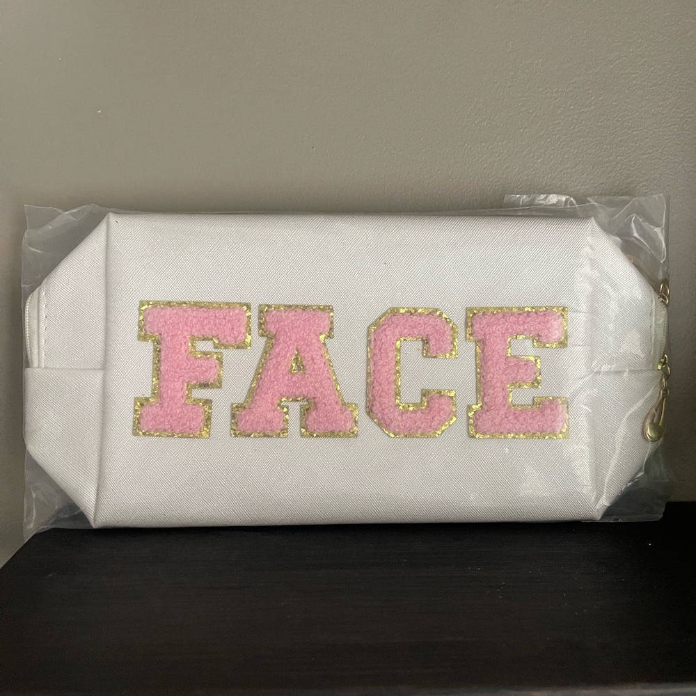 White Cosmetic Bag with Pink 'FACE' Lettering